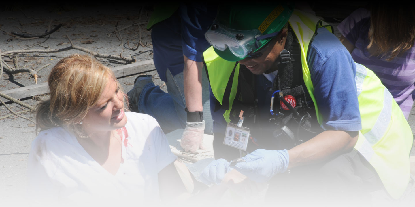 A member of the Community Emergency Response Team assists an injured woman